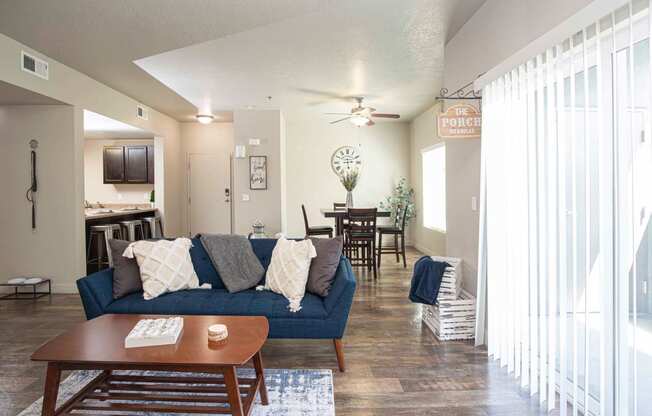 a living room with a blue couch and a coffee table