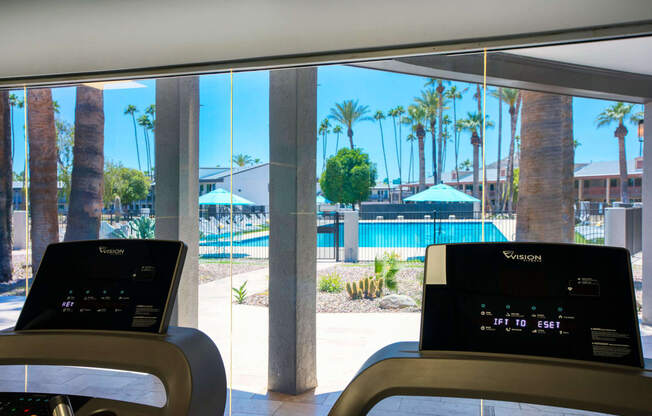 a view of a swimming pool from a treadmill in a hotel lobby at Presidio Palms Apartments, Tucson, AZ, 85701