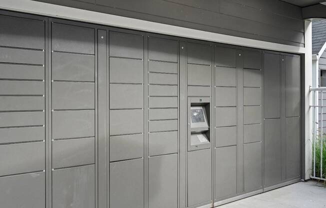 a large wall of garage doors with an atm in it