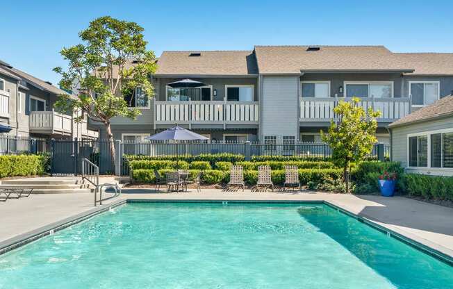 a swimming pool with a house in the background