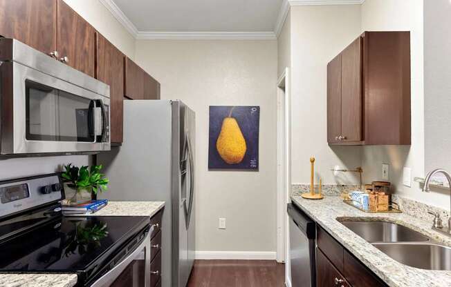 A kitchen with a black stove top oven and a black microwave.
