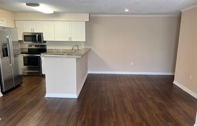 a kitchen with a hard wood floor