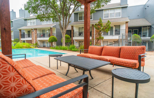 our apartments have a large pool and a patio with furniture