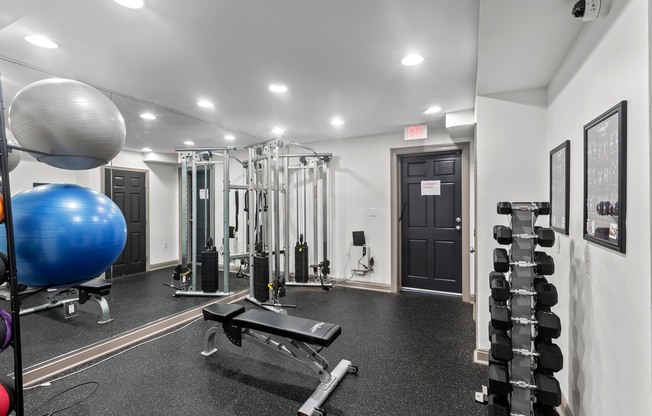 the gym is equipped with weights and cardio equipment at the preserve at great neck apartments