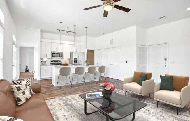 A modern living room with a brown leather couch and a black coffee table.