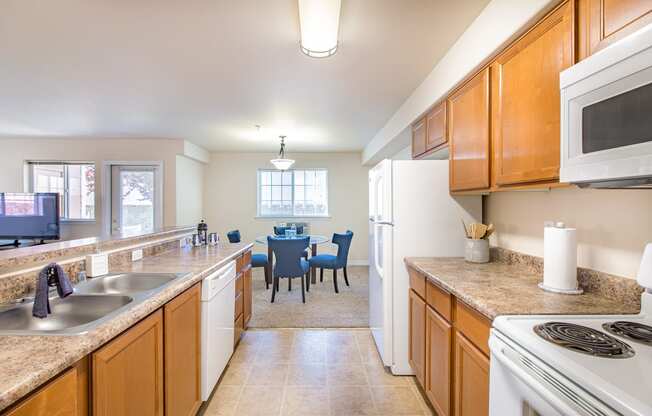 a kitchen and dining room with a table and a microwave  at Quail Springs, West Richland