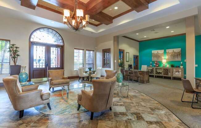 a lobby with chairs and tables and a large window