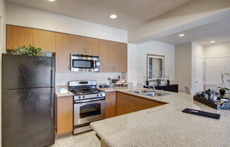 a kitchen with a refrigerator freezer and a stove top oven