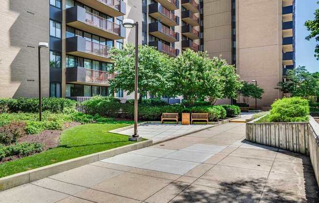 A modern apartment building with a well-maintained courtyard and landscaping.