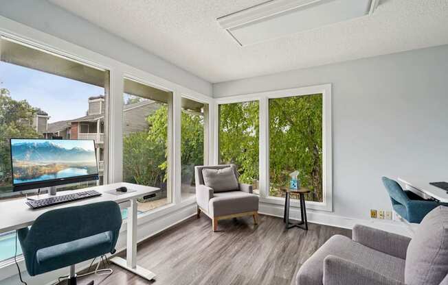 A sunny room with a desk and a couch.