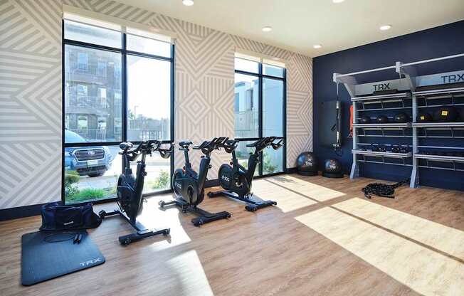 a home gym with exercise equipment and windows