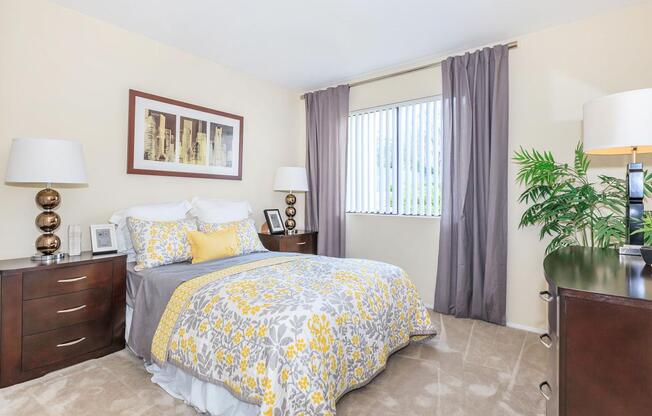 a bedroom with a bed and desk in a hotel room