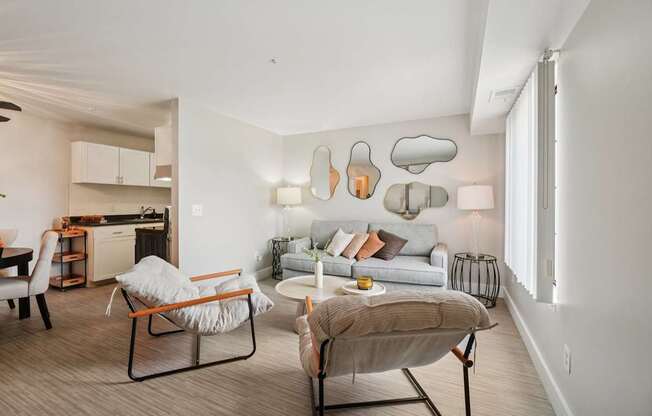 A modern living room with a grey sofa, a chair and a table.
