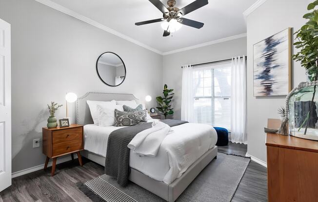 Mesa Verde Bedrooms Bright and Spacious Bedroom with Wood Look Vinyl Flooring Ceiling Fan and Crown Molding