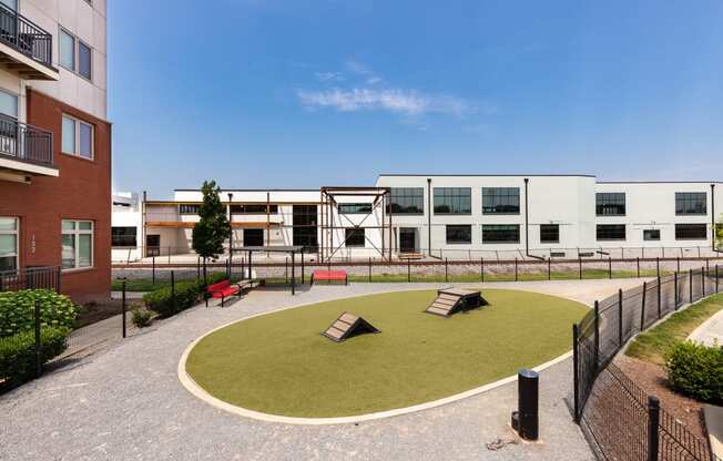 a courtyard with benches and a building in the background