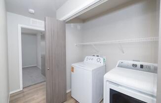 A small kitchen with a white oven and a white cabinet.