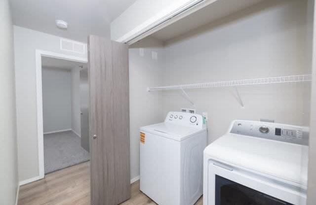 A small kitchen with a white oven and a white cabinet.