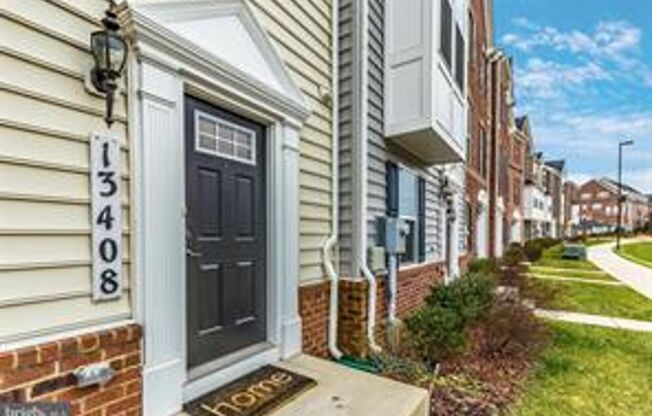 Three level townhouse with wood floor on main level, 2 car garage in the back