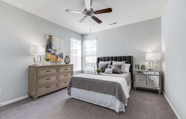 A bedroom with a bed, dresser, and nightstand.