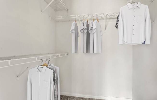 a white closet with white shirts hanging on a rack at Villages of Cypress Creek, Texas, 77070