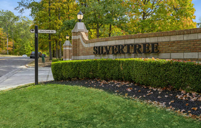 a view of the sign at the side of a brick wall