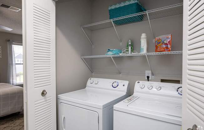 A white washing machine and dryer in a small laundry room.