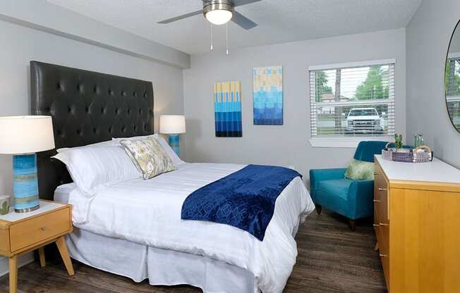 Mandarin Bay Apartments Jacksonville - Bedroom With Wood-Style Flooring, Ceiling Fan, Window, and Gray Walls