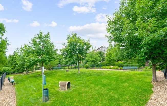 A park with a green lawn and trees.