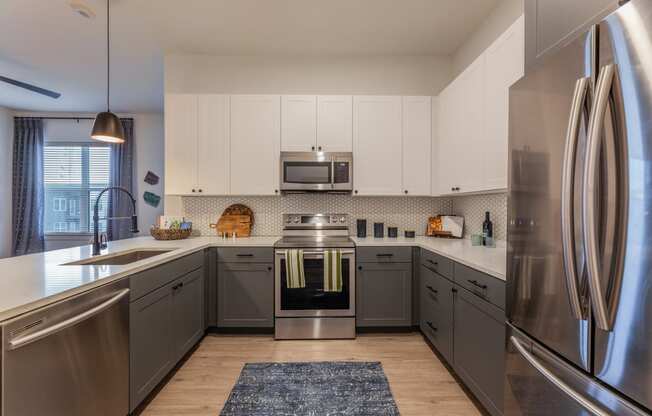 Apartments in Downtown Dallas for Rent- 4600 Ross- Kitchen with Stainless-Steel Appliances and Modern White & Grey Cabinets