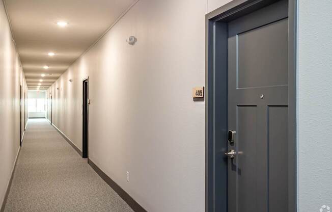 A long hallway with a door on the right.