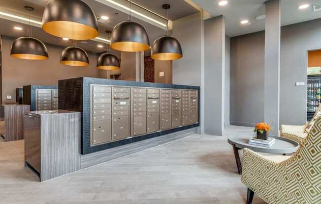 A reception area with a desk, chairs, and a row of lockers.