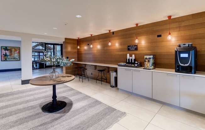 a kitchen with a coffee table and a refrigerator at Ashford Belmar Apartments, Colorado