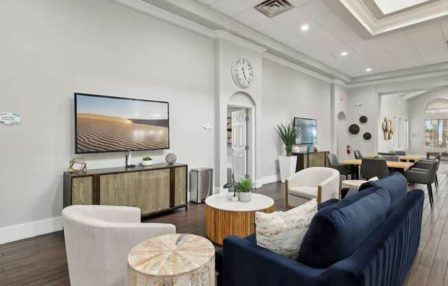 A living room with a large flat screen TV and a sofa.