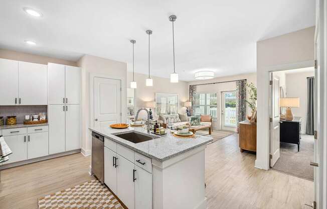 A kitchen with a sink, cabinets, and a dining table.