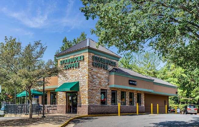 the facade of a restaurant with a street and trees