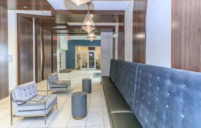 a lobby with a blue couch and chairs