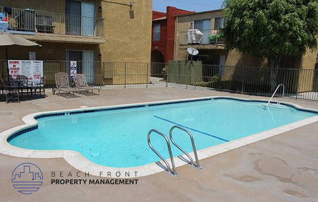 an empty swimming pool in front of an apartment building