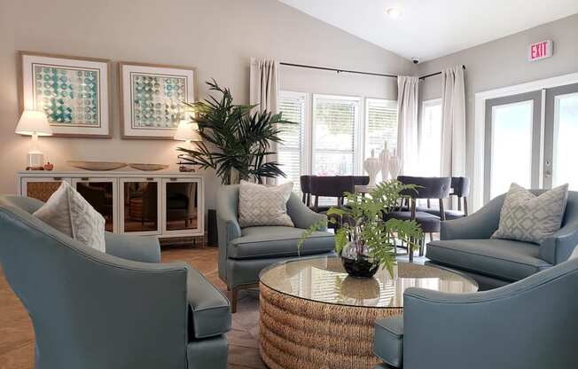 a living room with blue chairs and a table