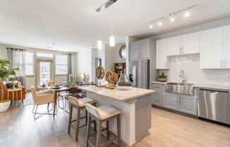 a kitchen and dining room with a large island and stainless steel appliances