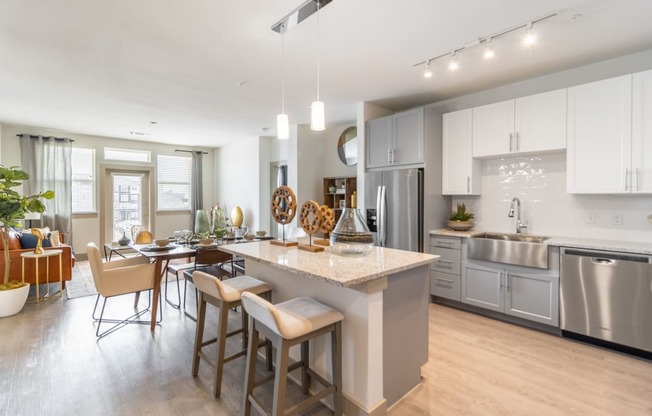 a kitchen and dining room with a large island and stainless steel appliances