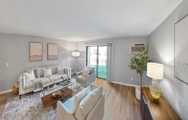 a living room with white couches and chairs and a sliding glass door