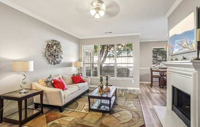 A living room with a white couch and a fireplace.