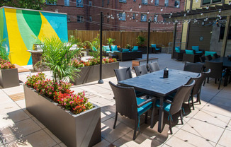 a patio with a table and chairs and a large colorful mural