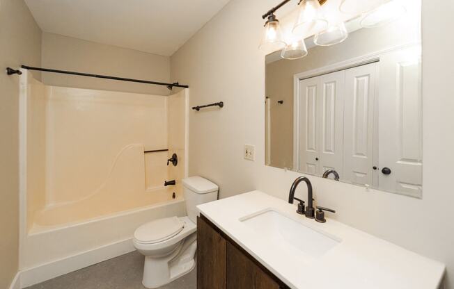 a bathroom with a sink and a toilet and a shower
