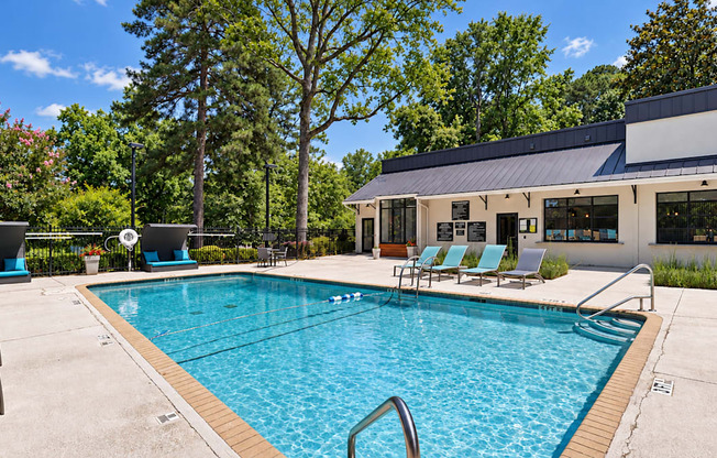 Swimming pool surrounded by a sundeck and lounge chairs at Icon Avondale Apartments in Decatur, GA.