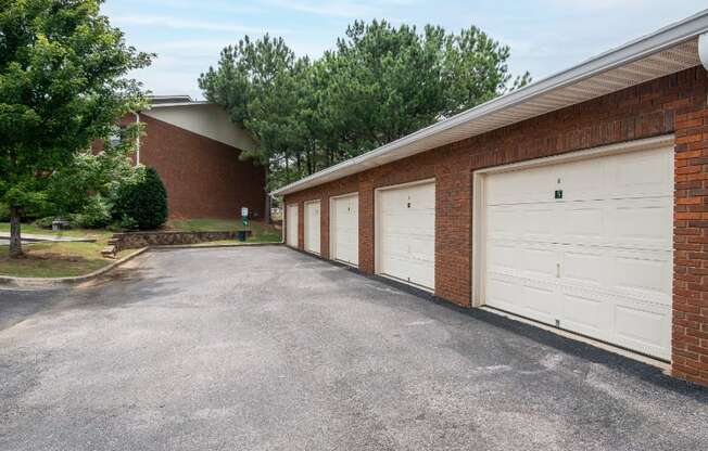 a row of garages in front of a brick building