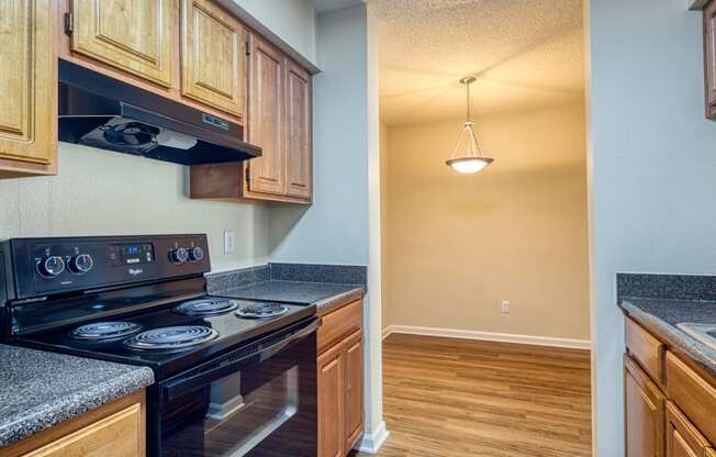 the kitchen of a home with wood cabinets and black appliances
