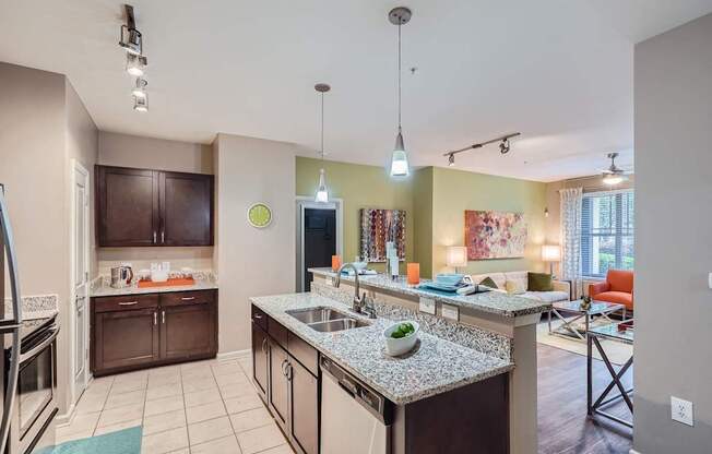 A kitchen with granite countertops and a large island.