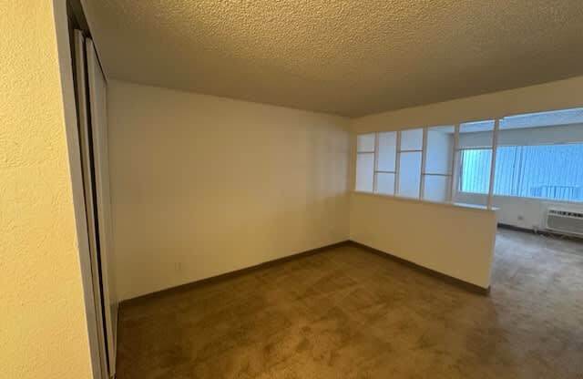 A room with a carpeted floor.