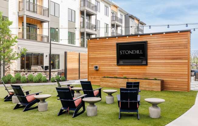 a group of tables and chairs in front of a wooden building